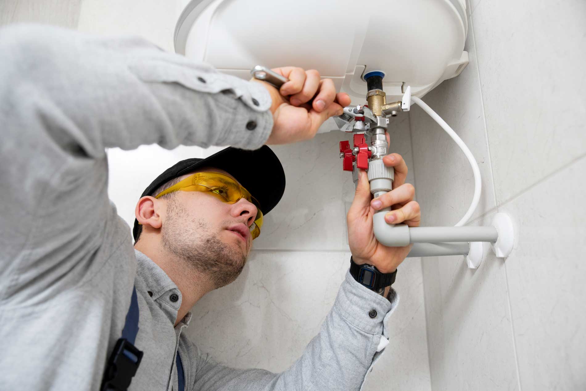 worker-repairing-water-heater image